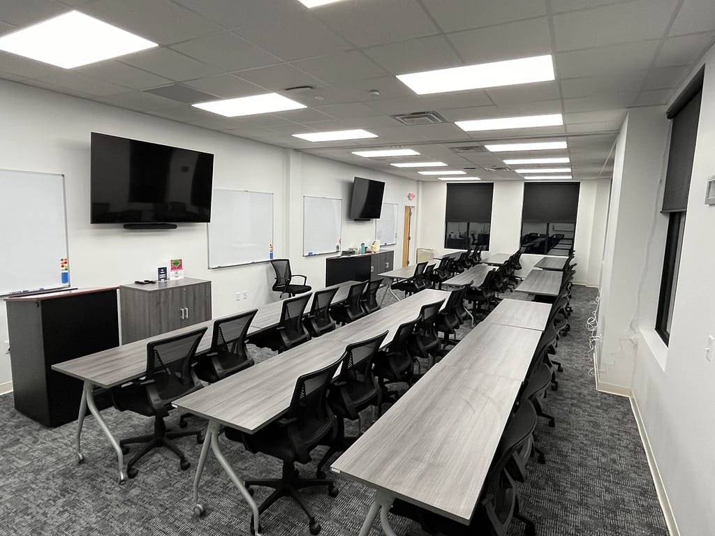 Assembled tables, cabinets, installed whiteboards and solar blinds